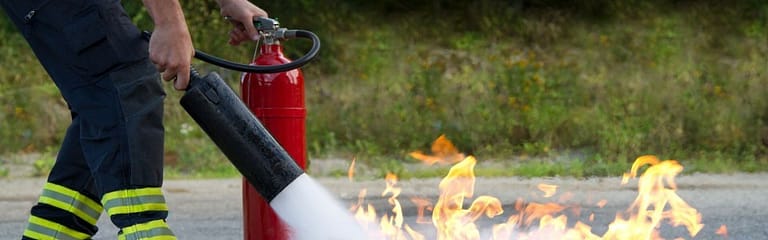 fire extinguisher being used to put out fire